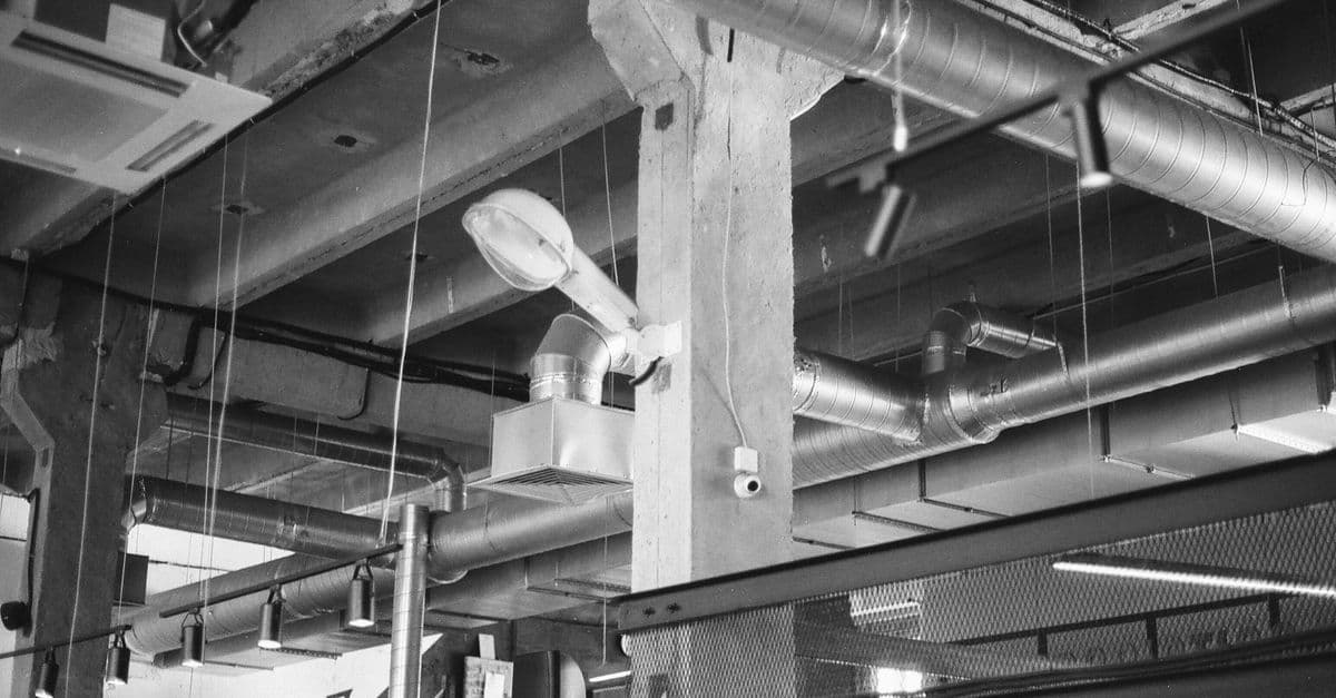 Metal ductwork running beneath a ceiling in a utility space