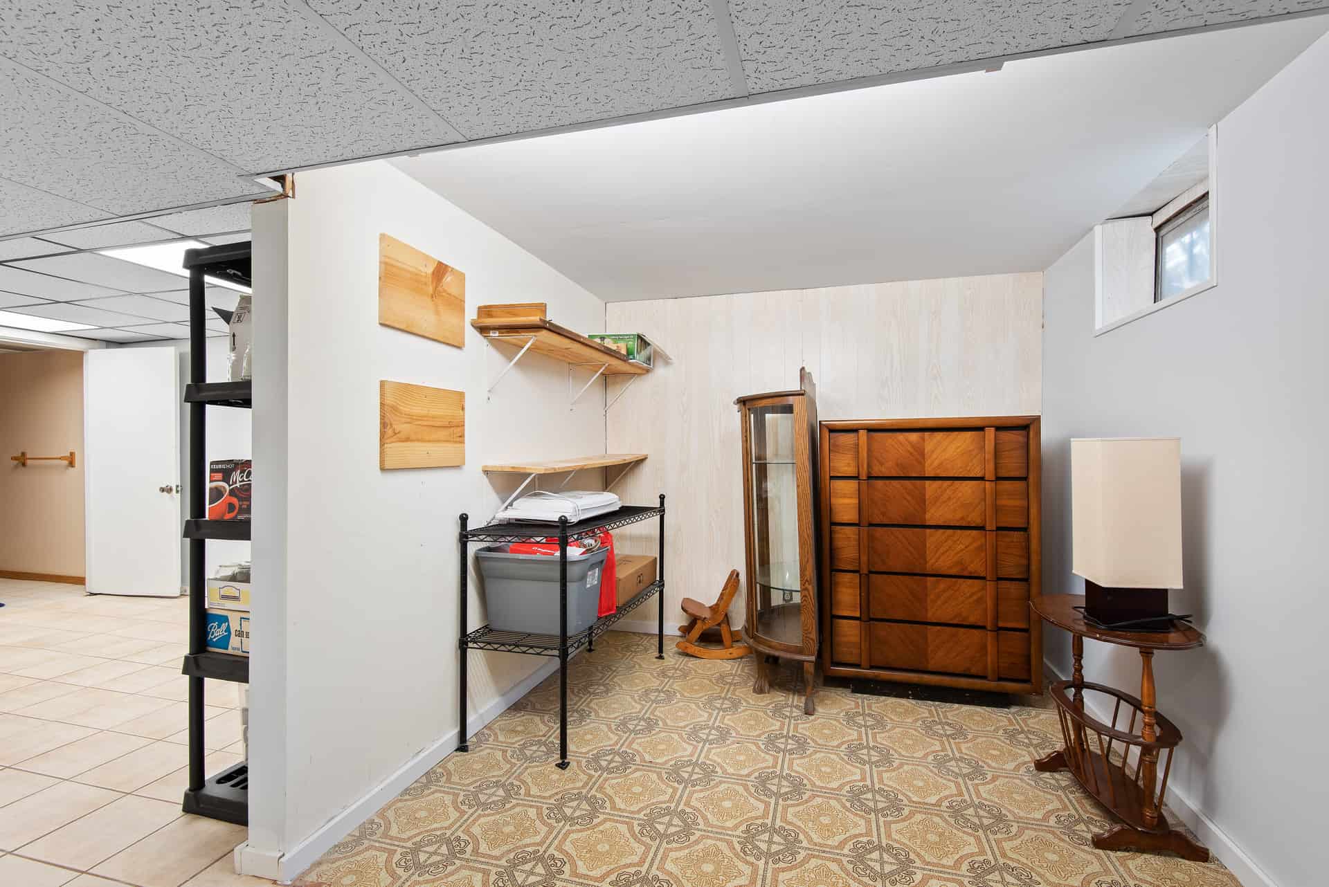 A finished basement room with a small window