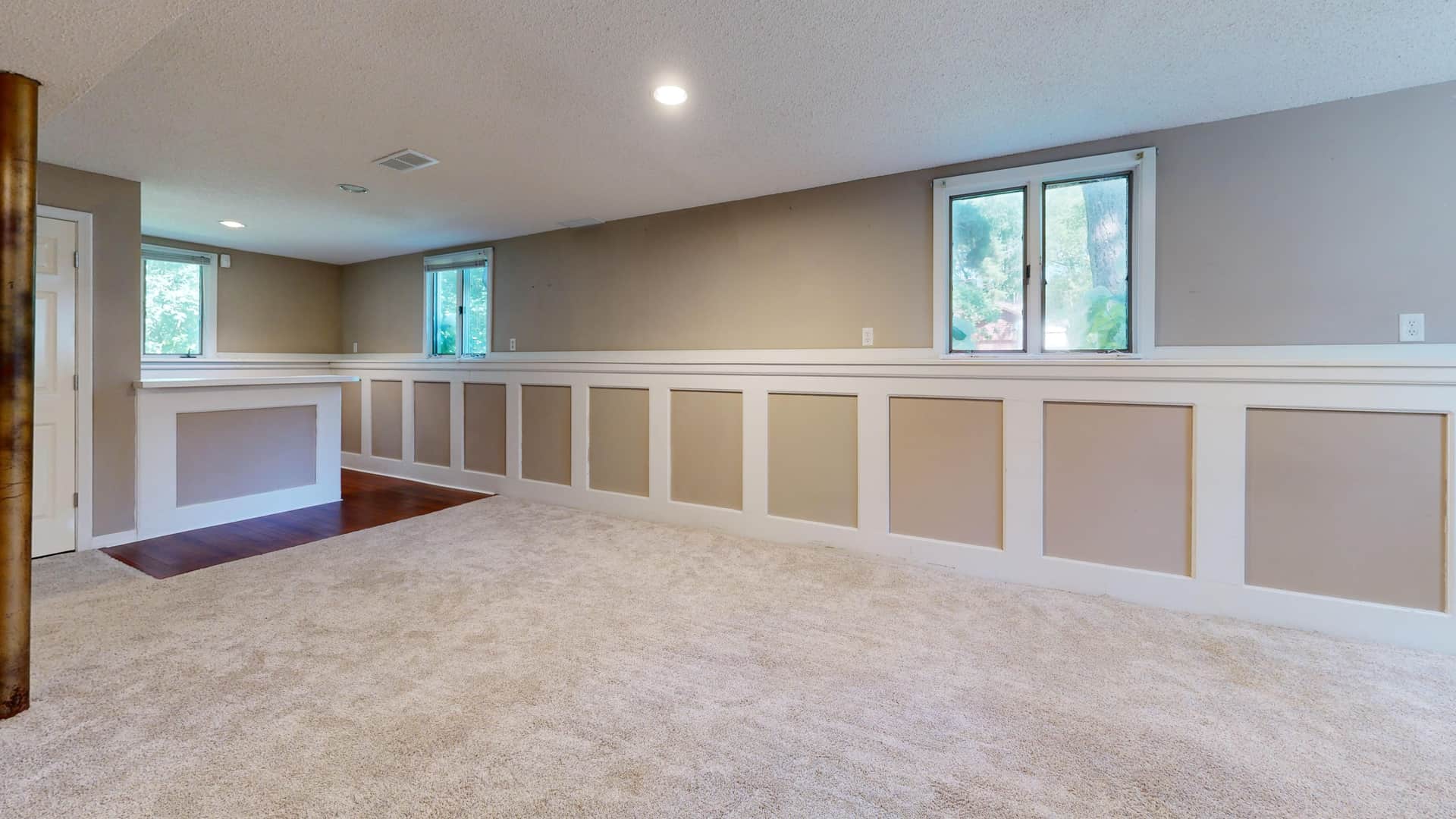 A finished basement with a small high window