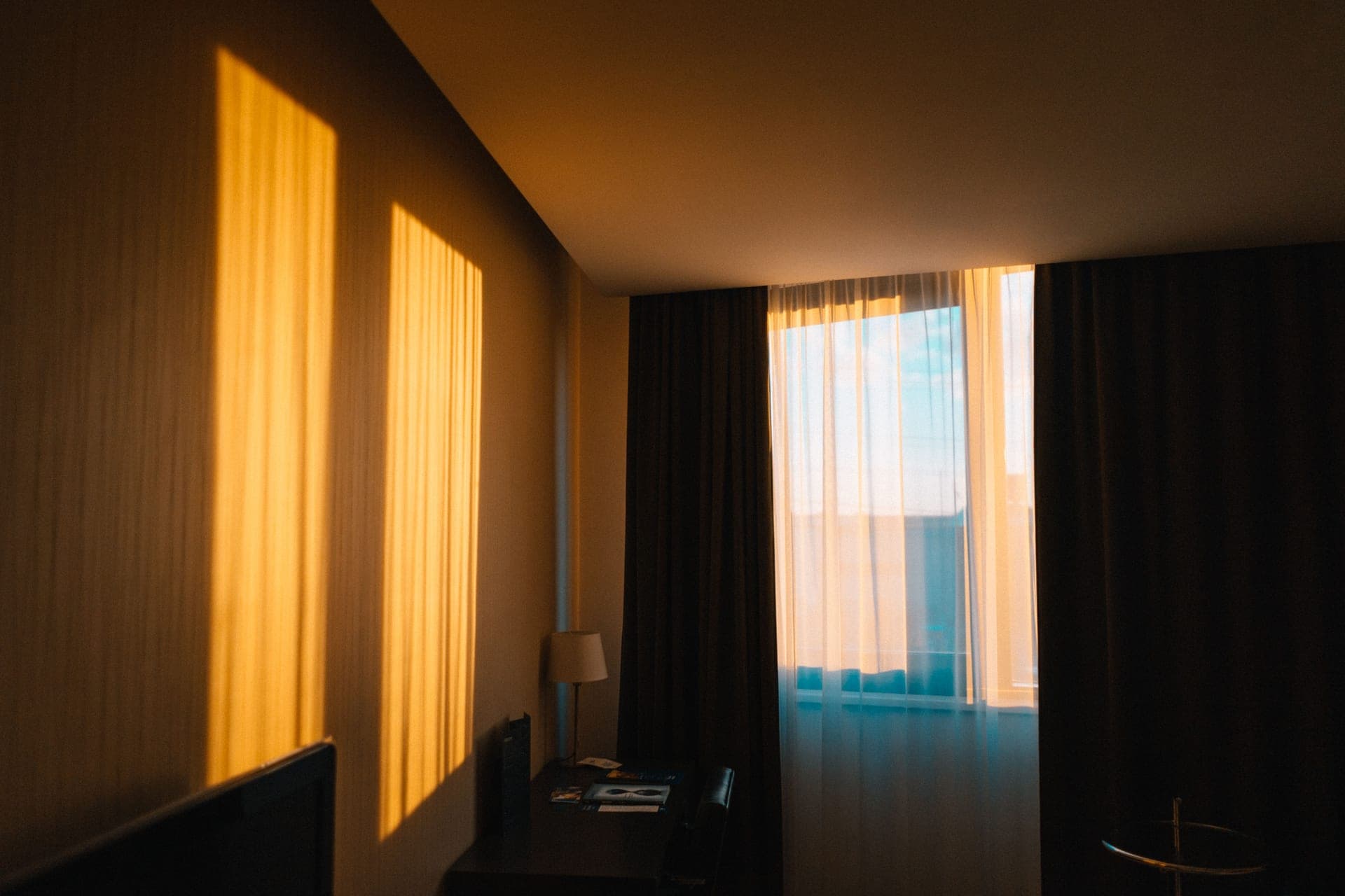 A quiet bedroom with morning light through the curtains