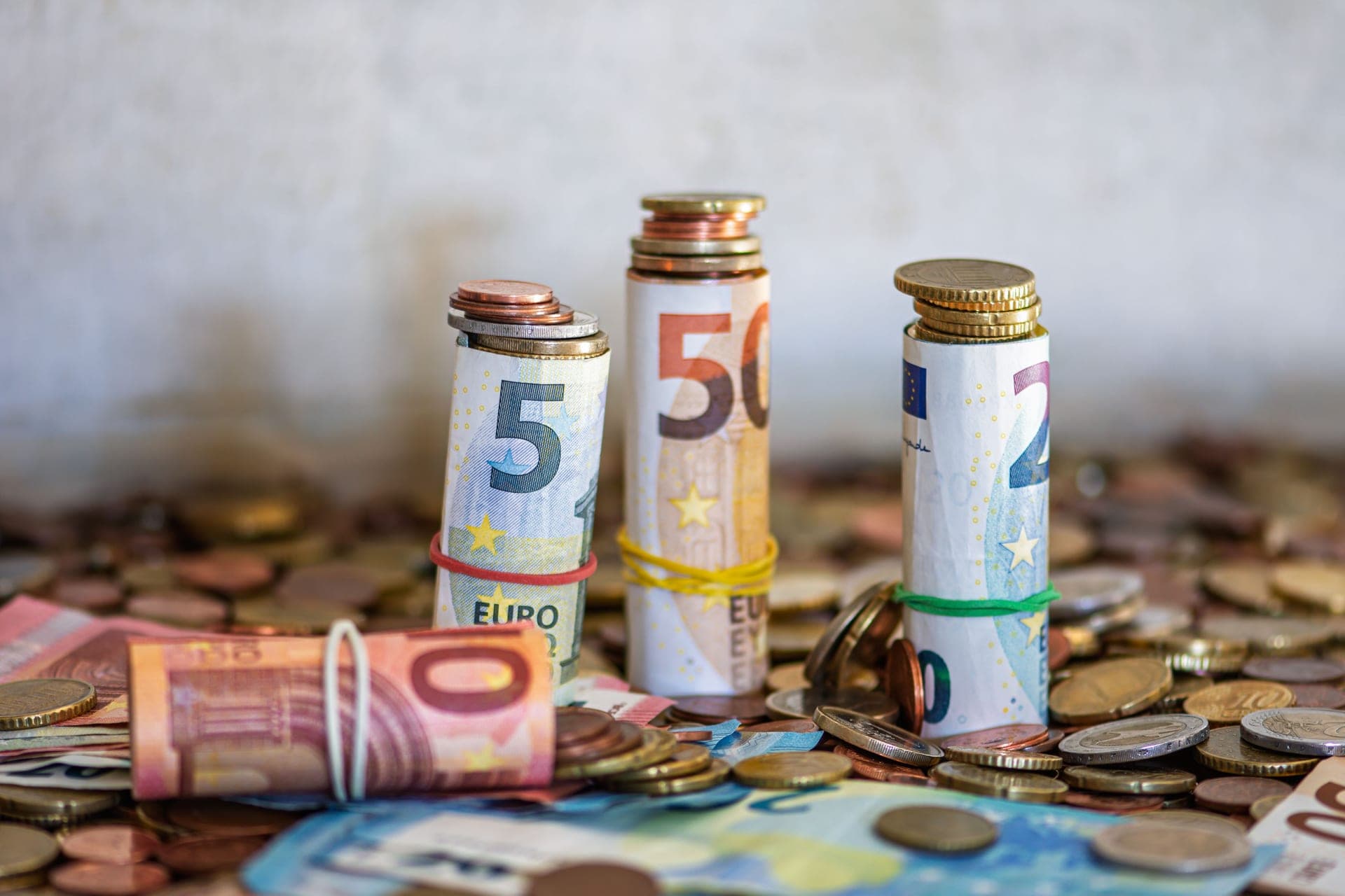 Coins and small notes on a wooden tabletop