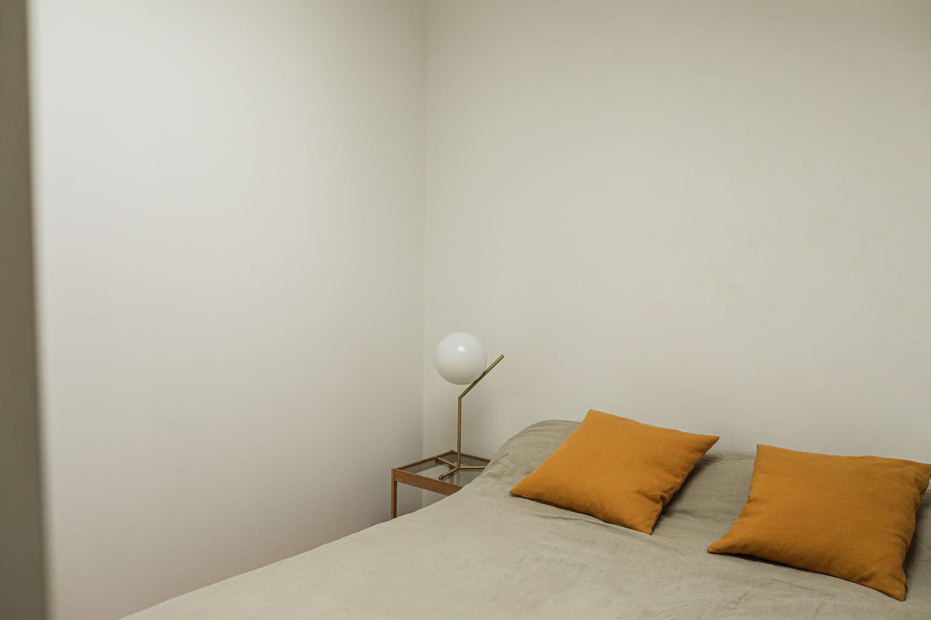 A minimal bedside table in a neutral bedroom