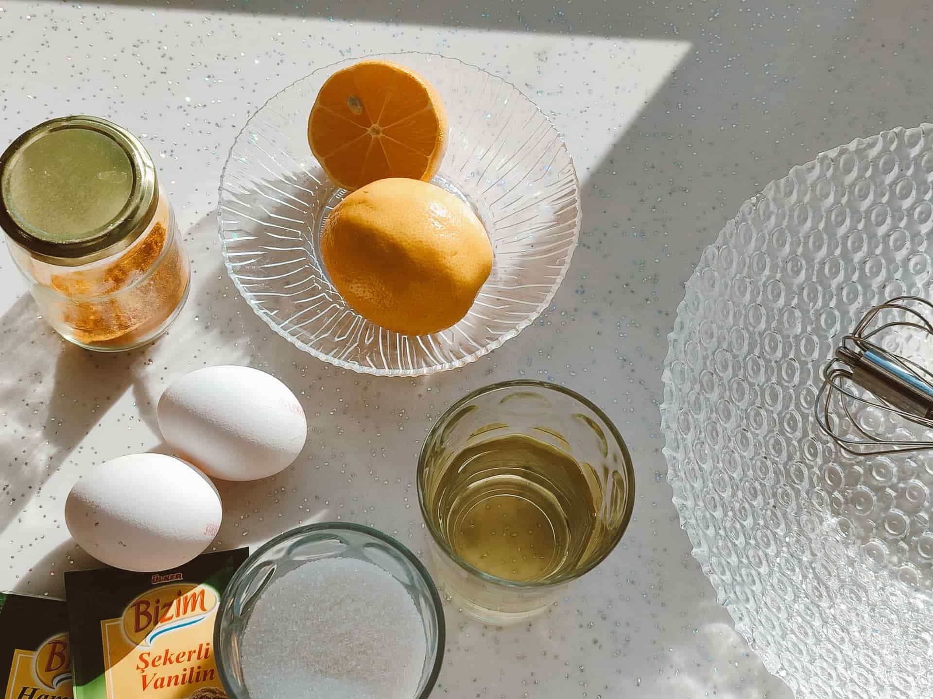 Lemons and a jar of white powder on a kitchen counter