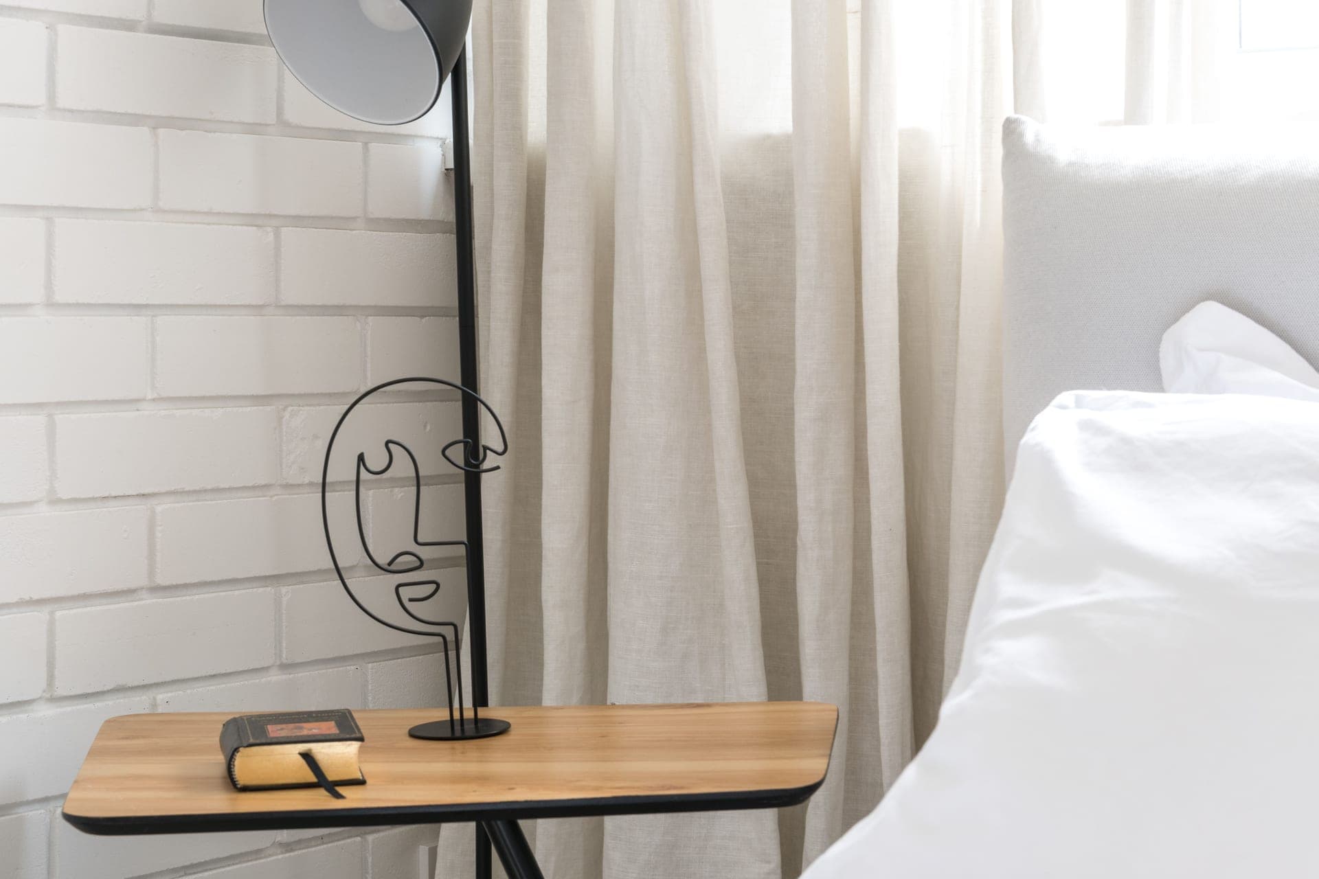 A minimalist bedroom with a bedside table