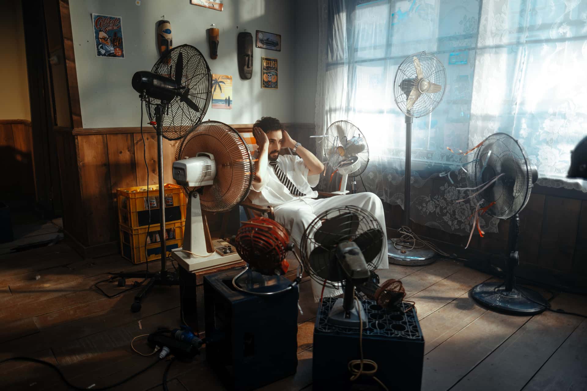 A fan-driven appliance on a wooden floor by a chair