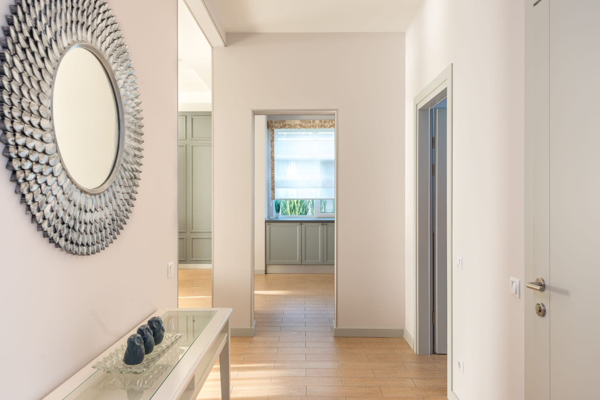 A hallway and doorway in a minimally furnished home