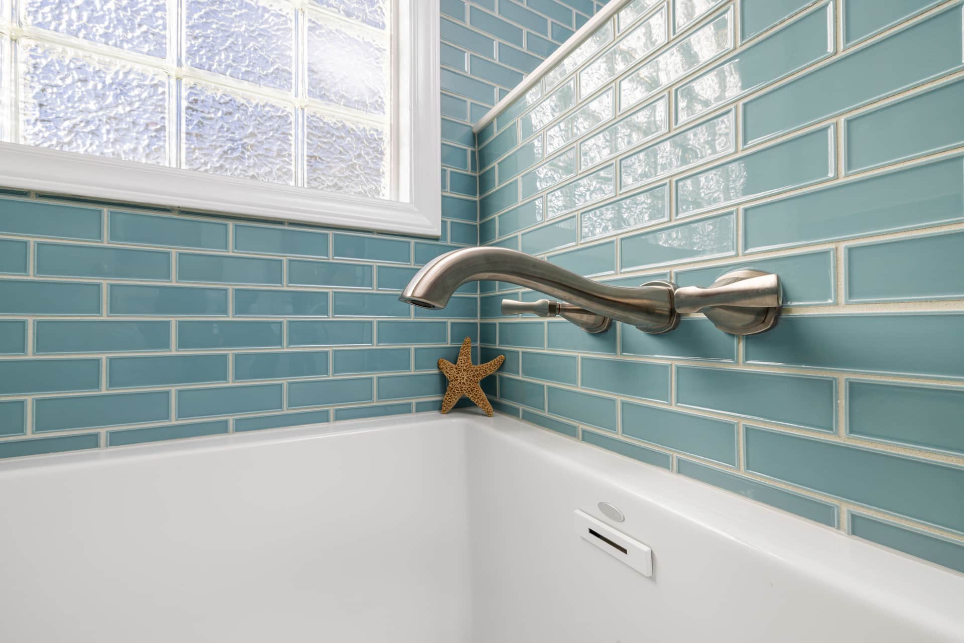 A bathroom tile corner where pink residue forms