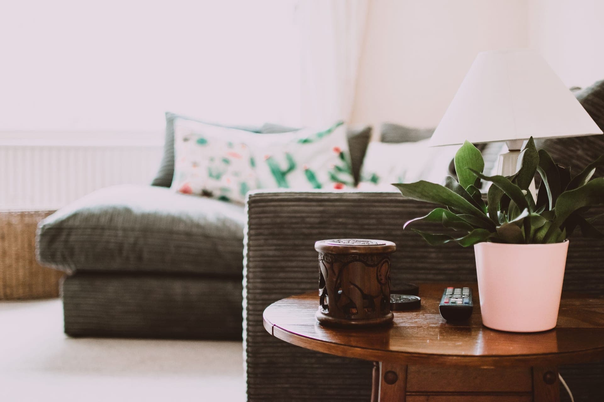 A side table beside a sofa in a softly lit living room