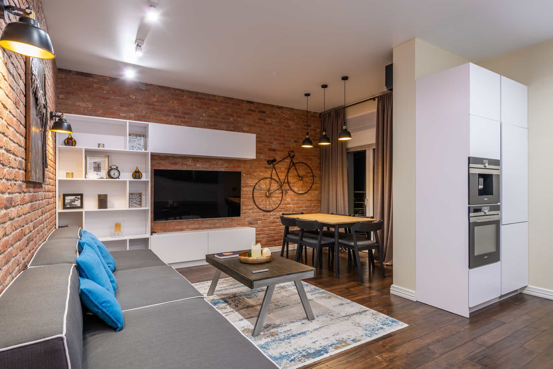 A living room with an appliance beside a sofa