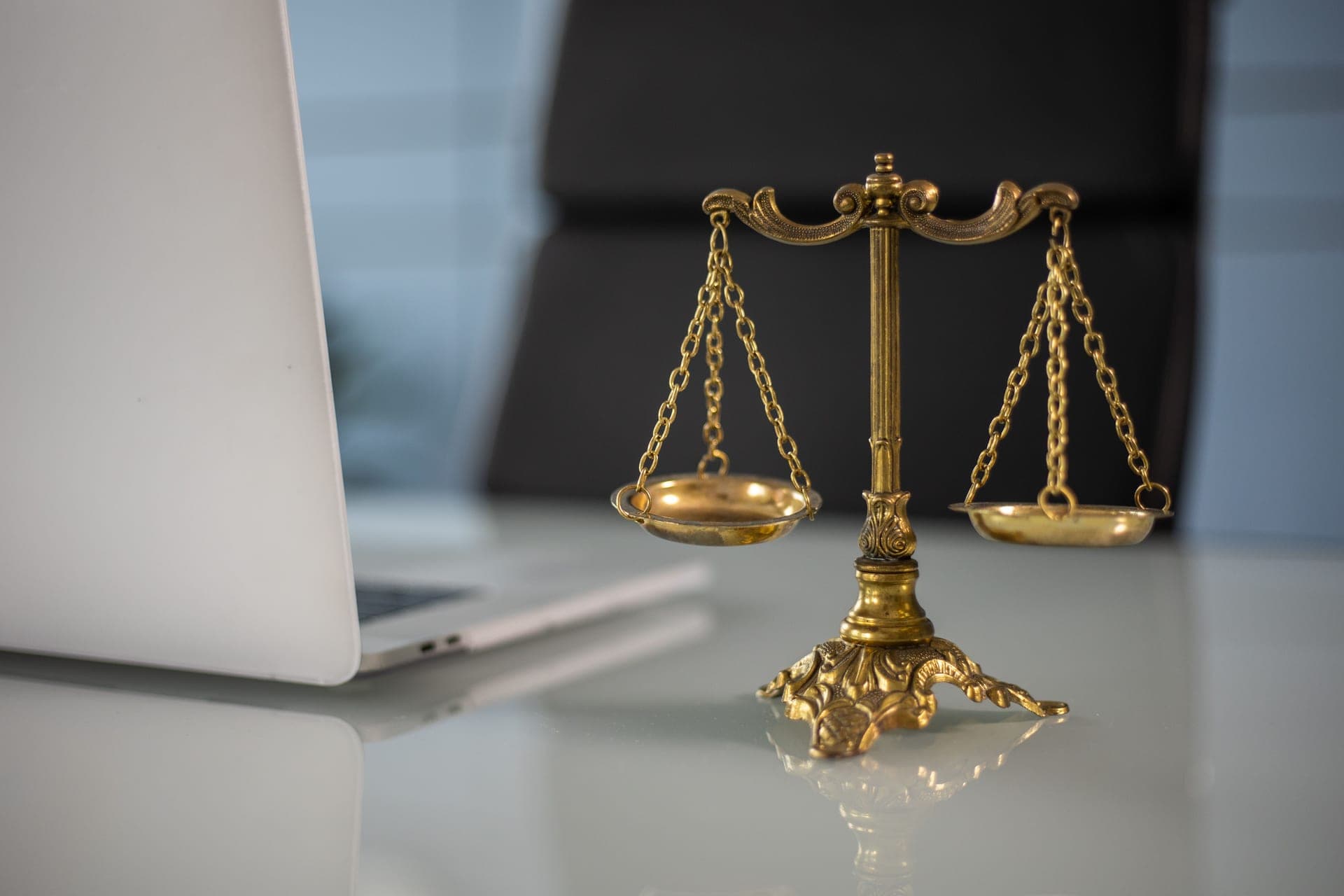 A balance scale on a wooden desk