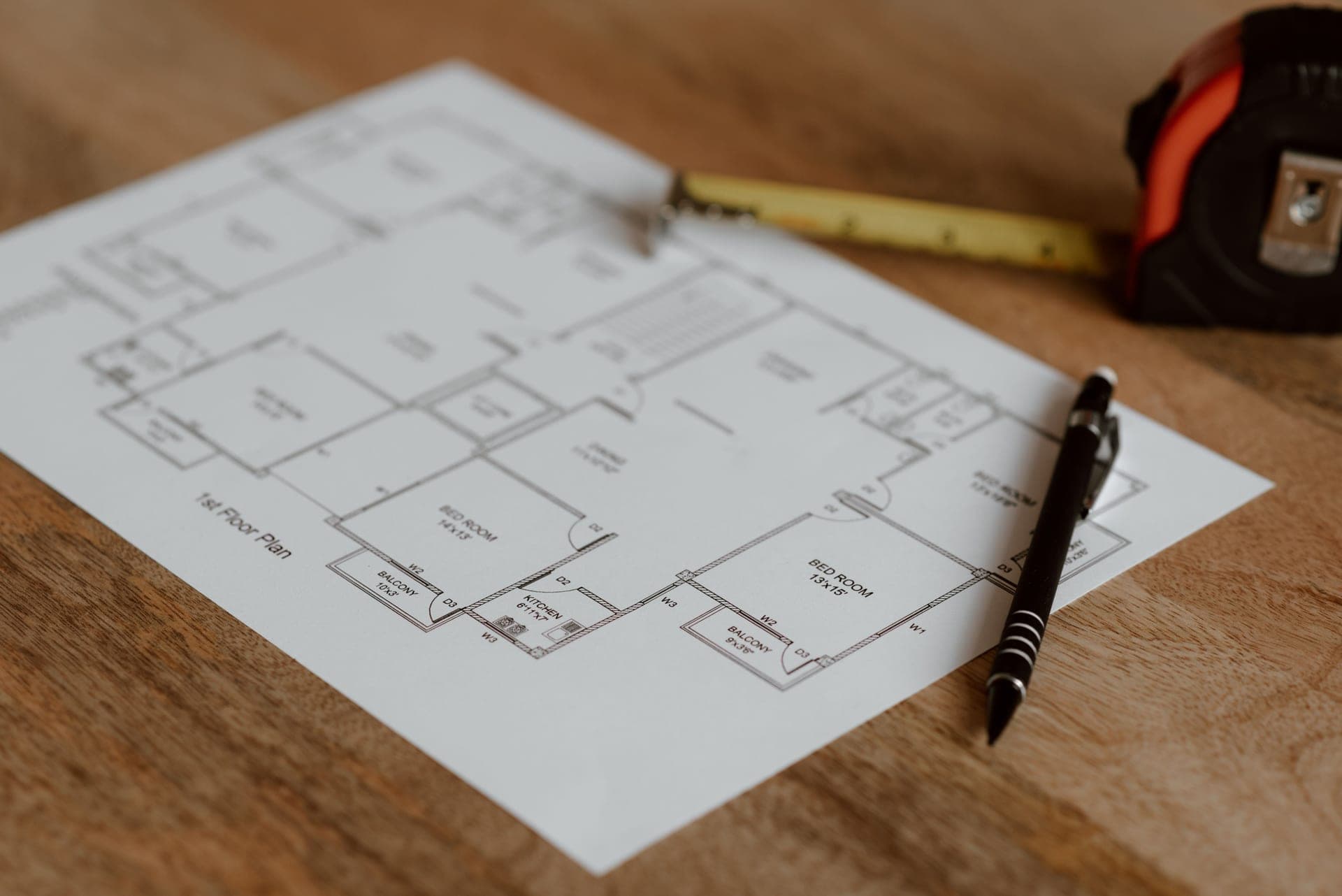 A house floor plan drawing on a desk